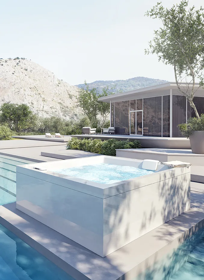 Minipiscina Realxdesign Collezione Jam nel verde con vista su architettura contemporanea.