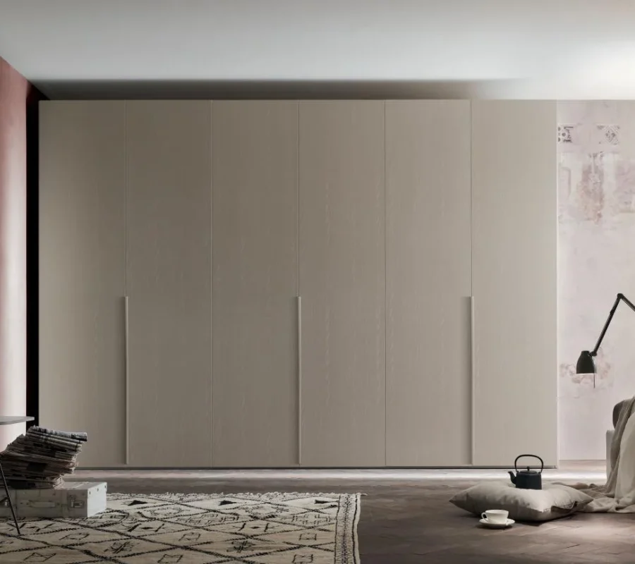 Armadio beige a sei ante con maniglie verticali in rilievo in una stanza elegante.